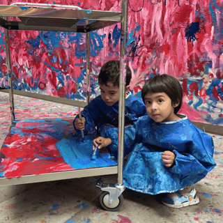 Two kids painting at The Flooded Garden at Tate